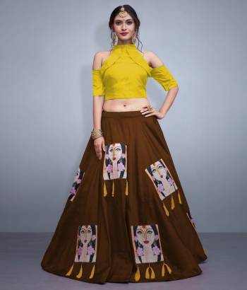 Here Is A Lovely Patterned Designer Lehenga Choli For Festive, Marriage Or Any Occasion Wear. Its Blouse Is In Yellow Color Paired With Contrasting Brown Lehenga. Its Blouse IS Fabricated On Nylon Silk Paired With Art Silk Lehenga. It IS Beautified with Patch Work And Tassels. 