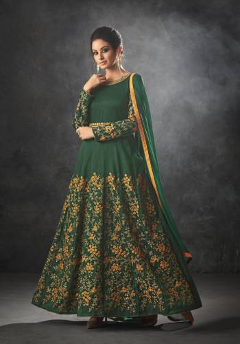 Celebrate This Festive Season Wearing This Designer Floor Length Suit In Dark Green. Its Top IS Fabricated on Art Silk Paired With Santoon Bottom And Chiffon Dupatta. It Has Heavy Embroidery Over The Lower Panel And Full Sleeves. 