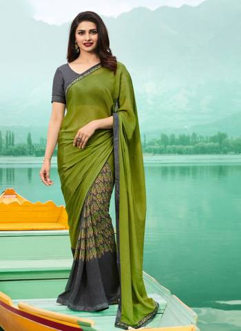 Unique Combination Is Here With This Designer Printed Saree In Green And Grey Color Paired With Grey Colored Blouse. This Saree Is Georgette Based Paired With Art Silk Fabricated Blouse. It Has Floral Prints And Embroidered Lace Border. 