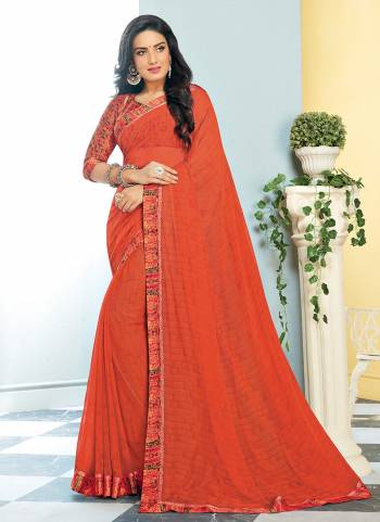 Orange And Red Color Induces Perfect Summery Appeal To Any Outfit, So Grab This Saree In Orange Color Paired With Contrasting Red Colored Blouse. This Saree Is Georgette Based Paired With Satin Fabricated Blouse. 