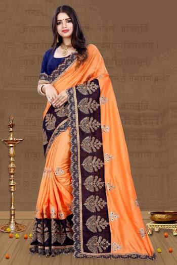 For A Proper Traditional Look, Grab This Designer Saree In Traditional Color Pallete With This Light Orange Colored Saree Paired With Contrasting Navy Blue Colored Blouse. This Saree And Blouse Are Art Silk Based Beautified With Embroidery All Over. 