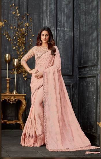 Grace and glamour interwine efficiently in this pretty pastel saree . The added frill and dainty embroidery makes it quite a charmer. 