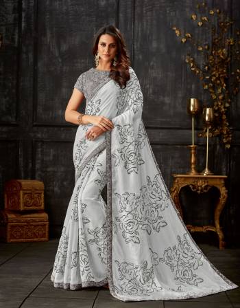 Get ready to look picture perfect in this exquisitely designed Pale grey saree. Drape it in classic nivi drape to look like a bollywood diva. 