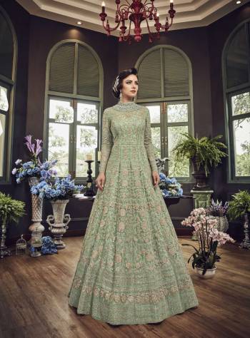 Add This Beautiful Heavy Designer Floor Length Suit In Pastel Green Color Paired With Pastel Green Colored Bottom And dupatta. Its Top And Dupatta Are Net Fabricated Paired With Art Silk Bottom. Also Its Top Is Beautified With Heavy Embroidery All Over.