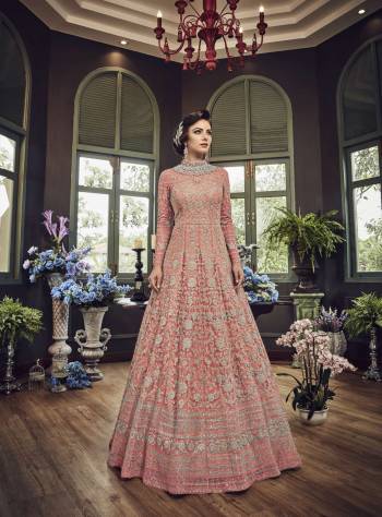 Add This Beautiful Heavy Designer Floor Length Suit In Pink Color Paired With Pink Colored Bottom And dupatta. Its Top And Dupatta Are Net Fabricated Paired With Art Silk Bottom. Also Its Top Is Beautified With Heavy Embroidery All Over.