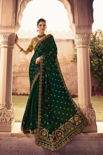 Celebrate This Festive And Wedding Season Wearing This Designer Saree In Dark Green Color Paired With Beige colored Blouse. This Saree Is Fabricated On soft Silk Paired With Art Silk Fabricated Blouse. 