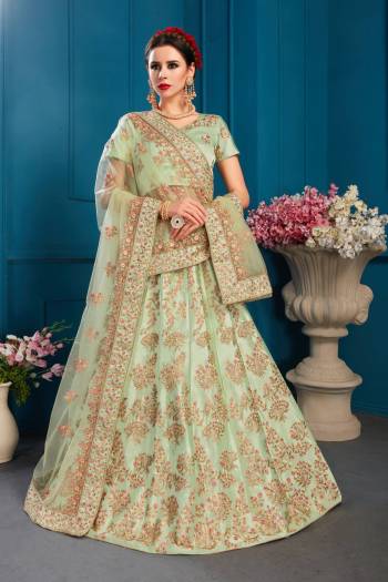 This Season Is About Subtle Shades And Pastel Play So Grab This Designer Heavy Lehenga Choli In Pastel Green Color Paired With Pastel Green Colored Dupatta. Its Blouse And Lehenga Are Satin Based Paired With Net Fabricated Dupatta. 