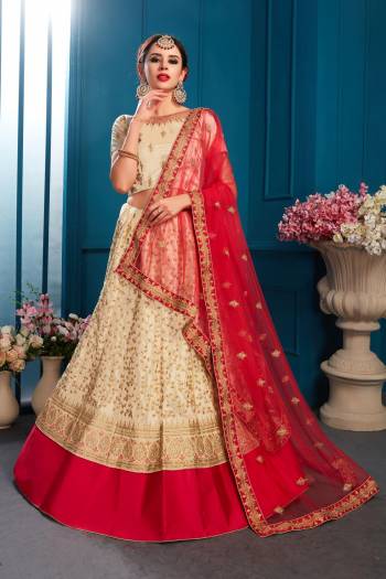 Here Is A Rich And Elegant Looking Designer Lehenga Choli With Royal Color Pallete. This Lehenga Choli IS In Cream Color Paired With Red Colored Dupatta. Its Blouse And Lehenga Are Satin Based Paired With Net Fabricated Dupatta. 