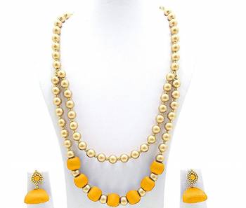 Grab This Beautiful Double Layered Necklace Set Made With Pearls And Resham Thread Balls. This Necklace Set Comes With A Pretty Pair Of Earrings, Pair This Up Any Same Or Contrasting Colored Ethnic Attire. Buy Now.