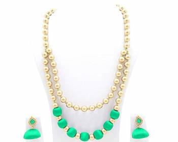 Grab This Beautiful Double Layered Necklace Set Made With Pearls And Resham Thread Balls. This Necklace Set Comes With A Pretty Pair Of Earrings, Pair This Up Any Same Or Contrasting Colored Ethnic Attire. Buy Now.