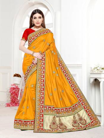 Celebrate This Festive Season Wearing This Lovely Designer Saree In Bright Yellow Color Paired With Contrasting Red Colored Blouse. This Saree And Blouse Are Silk Based Beautified With Embroidery. 