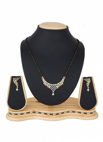 To Give An Elegant Look To Your Neckline, Grab This Pretty Elegant Looking Mangalsutra Set In Golden Color Beautified With Diamond Work All Over. It Can Be Paired With Any Colored Attire. Buy Now.