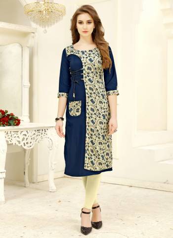 Add This Lovely Kurti To Your Wardrobe In Blue And Cream Color Fabricated on Rayon. It Has Pretty Floral Prints. Buy Now.