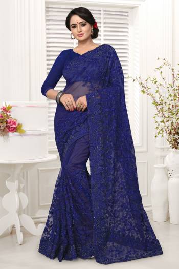 Shine Bright In This Beautiful Designer Royal Blue Colored Saree Paired With Royal Blue Colored Blouse. It Is Net Based Beautified With Tone To Tone Embroidery. Buy Now.