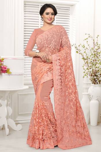 A Must Have Shade In Ever Womens Wardrobe Is Here With This Designer Saree In Peach Color. This Saree And Blouse Are Fabricated On Net Beautified With Heavy Embroidery All Over. 