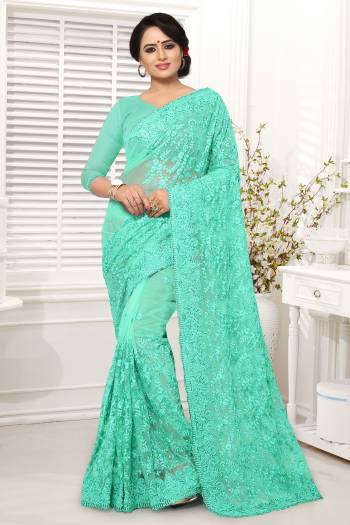 Grab This Beautiful Designer Saree In Sea Green Color Paired With Sea Green Colored Blouse. This Saree And Blouse Are Fabricated On Net Beautified With Tone To Tone Work All Over It. 