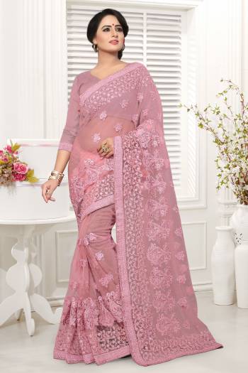 Look Pretty In This Lovely and EveryOnes Favourite Pink Colored Saree Paired With Pink Colored Blouse, This Saree And Blouse are Fabricated On Net Beautified With Same Colored Heavy Embroidery Work. 