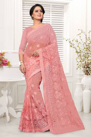 A Must Have Shade In Ever Womens Wardrobe Is Here With This Designer Saree In Peach Color. This Saree And Blouse Are Fabricated On Net Beautified With Heavy Embroidery All Over. 