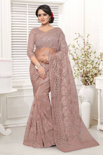 New Shade Is Here To Add Into Your Wardrobe With This Designer Saree In Mauve Color Paired With Mauve Colored Blouse. This Saree And Blouse Are Net Based Which Comes With A Satin Inner. Buy This Now.