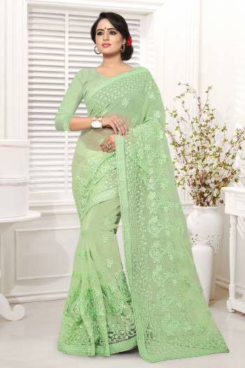 Grab This Beautiful Designer Saree In Light Green Color Paired With Light Green Colored Blouse. This Saree And Blouse Are Fabricated On Net Beautified With Tone To Tone Work All Over It. 