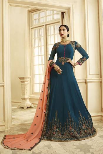 Add This Rich Looking Designer Floor Length Suit To Your Wardrobe In Blue Color Paired With Contrasting Peach Colored Dupatta. This Suit Is Fabricated On Georgette Paired With Santoon Bottom And Georgette Dupatta.