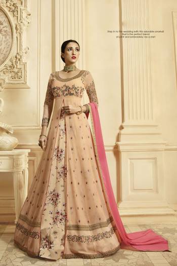 Look The Prettiest Of All Wearing This Designer Floor Length Suit In Light Peach Color Paired With Contrasting Pink Colored Dupatta. It IS Georgette Based With Heavy Embroidery Giving It An Enhanced Look. 