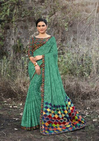 For Your Semi-Casual Wear, Grab This Pretty Saree In Sea Green Color Paired With Multi Colored Blouse. This Saree And Blouse Are Fabricated On Satin Georgette Beautified With Prints All Over. 