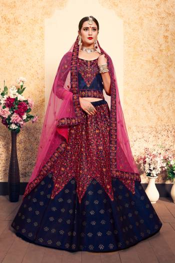 For A Royal Look, Grab This Rich Color Pallet Heavy Designer Lehenga Choli In Navy Blue Color Paired With Contrasting Dark Pink Colored Dupatta. This Lehenga Choli Is Satin Based Paired With Net Fabricated Dupatta. Both The Fabrics Ensures Superb Comfort Throughout The Gala.