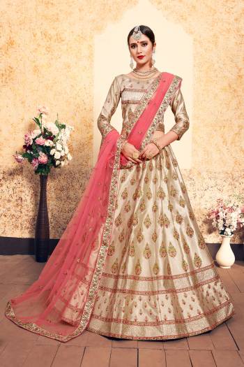 Simple And Elegant Looking Heavy Designer Lehenga Choli Is Here In Cream Color Paired With Contrasting Peach Colored Dupatta. Its Blouse And Lehenga Are Satin Based With Heavy Embroidery Paired With Net fabricated Dupatta. It Is Light In Weight And Ensures Superb Comfort.