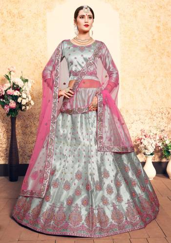 Flaunt Your Rich And Elegant Taste Wearing This Heavy Designer Lehenga Choli In Steel Grey Color Paired With Contrasting Pink Colored Dupatta. This Lehenga Choli Is Fabricated On Satin Paired With Net Fabricated Dupatta. It Has Pretty Resham Embroidery With Stone Work. Buy Now.