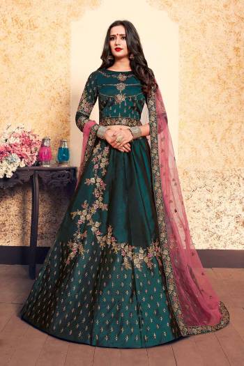 Enhance Yout Personality Wearing This Designer Lehenga Choli In Dark Teal Green Color Paired With Contrasting Pink Colored Dupatta. This Pretty Lehenga Choli Is Fabricated On Satin Paired With Net Fabricated Dupatta. 