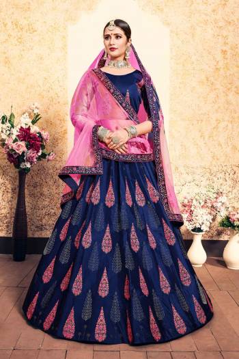 Here Is A Beautiful Designer Heavy Lehenga Choli In Blue Color Paired With Contrasting Pink Colored Dupatta. Its Blouse and Lehenga Are Satin Fabricated Paired With Net Fabricated Dupatta. Grab It Soon.