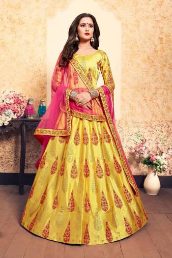 Here Is A Beautiful Designer Heavy Lehenga Choli In Yellow Color Paired With Contrasting Fuschia Pink Colored Dupatta. Its Blouse and Lehenga Are Satin Fabricated Paired With Net Fabricated Dupatta. Grab It Soon.