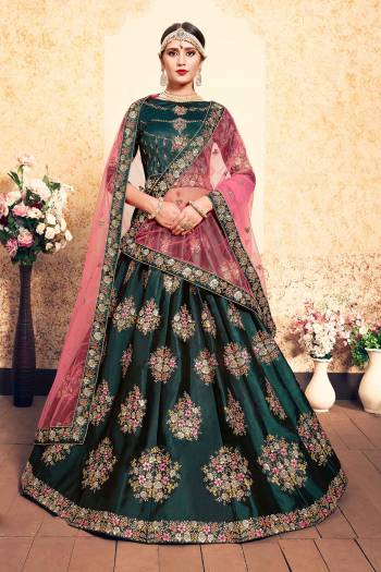 You Will Definitely Earn Lots Of Compliments Wearing This Designer Lehenga Choli In Teal Green Color Paired With Contrasting Pink Colored Dupatta. Its Blouse And Lehenga Are Satin Based Paired With Net Fabricated. Buy Now.