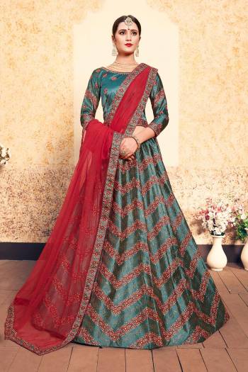 New And Unique Patterned Designer Lehenga Choli Is Here In Teal Green Color Paired With Contrasting Red Colored Dupatta. Its Blouse And Lehenga Are Fabricated On Satin Paired With Net Fabricated dupatta. All Its Fabrics Are Light Weight And Easy To Carry All Day Long. 