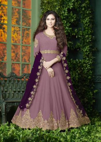 Flaunt Your Rich And Elegant Look Wearing This Designer Floor Length Suit In Pink Color Paired With Pink Colored Bottom And Dark Purple Colored Dupatta. It Top Is Fabricated On Georgette Paired With Santoon Bottom And Georgette Dupatta. It Has Very Pretty Embroidery over The Top And Dupatta. Buy Now.