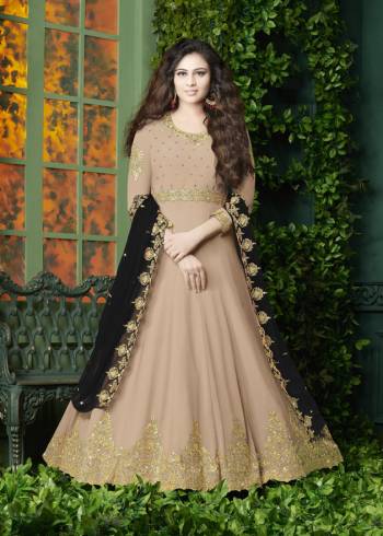 Flaunt Your Rich And Elegant Look Wearing This Designer Floor Length Suit In Beige Color Paired With Beige Colored Bottom And Black Colored Dupatta. It Top Is Fabricated On Georgette Paired With Santoon Bottom And Georgette Dupatta. It Has Very Pretty Embroidery over The Top And Dupatta. Buy Now.