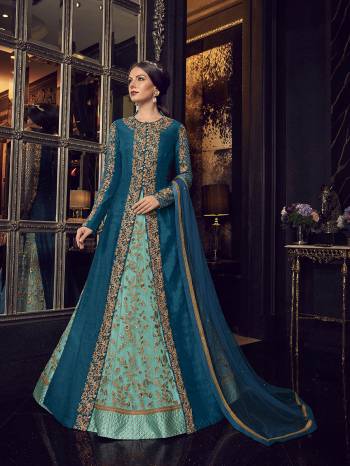 Add This Elegant And New Patterned Indo-Western Dress To Your Wardrobe In Shades Of Blue. It Has Very Pretty Aqua Blue Colored Gown With A Blue Colored Jacket Paired With Aqua Blue Colored Embroidered Pants And Blue Dupatta. Its Heavy Embroidered Gown Is Net Based Paired With Art Silk Jacket , Art Silk Pant And Net Fabricated Dupatta. 