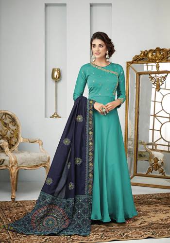 Add This Designer Floor Length Suit In Shades Of Blue To Your Wardrobe. Its Top and Bottom Are In Turquoise Blue Color Paired With Navy Blue Colored Dupatta, Its Top Is Fabricated On Satin Georgette Paired With Santoon Bottom And Art Silk Dupatta. 