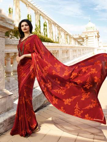 You Will Definitely Earn Lots Of Compliments Wearing This Pretty Saree In Red Color Paired With Red Colored Blouse. This Saree Is Fabricated On Georgette Paired With Art Silk Fabricated Blouse. It Is Beautified With Prints All Over. 