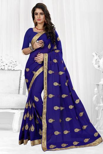 Celebrate This Festive Season Wearing This Rich And Elegant looking Designer Saree Fabricated On Georgette. It Is Beautified with Jari Embroidered Butti All Over It With Lace Border. 