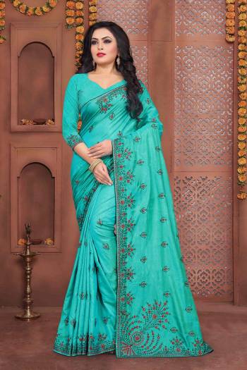 Flaunt Your Rich And Elegant Taste Wearing This Designer Embroidered Saree In Turquoise Blue Color Paired With Turquoise Blue Colored Blouse. This Saree And Blouse Are Fabricated On Art Silk Beautified With Thread Embroidery And Stone Work.