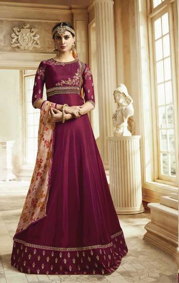 Shine Bright Wearing This Designer Floor Length Suit In Dark Magenta Pink Color Paired With Contrasting Peach Colored Dupatta. Its Top Is Fabricated On Soft Silk Paired With Santoon Bottom And Georgette Dupatta. Its Pretty Color Combination Will earn You Lots Of Compliments From Onlookers. 