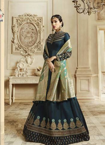 You Will Definitely Earn Lots Of Compliments Wearing This Designer Floor Length Suit In Prussian Blue Color Paired With Contrasting Sea Green Colored Dupatta. Its Top Is Fabricated On Soft Silk Paired With Santoon Bottom And Banarasi Art Silk Dupatta. All Its Fabric Ensures Superb Comfort All Day Long. 