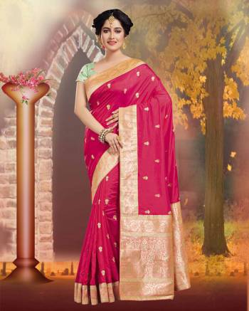 Shine Bright In this Silk Based Dark Pink Colored Saree Paired With Contrasting Pastel Green Colored Blouse. It Is Beautified With Weave And Jari Embroidery. 