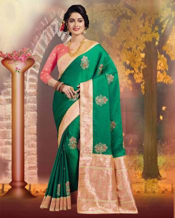 Celebrate This Festive Season Wearing This Designer Saree In Dark Green Color Paired With Contrasting Peach Colored Blouse. This Saree And Blouse Are Silk Based Beautified With Weave And Jari work.