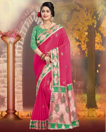 Shine Bright In this Silk Based Dark Pink Colored Saree Paired With Contrasting Green Colored Blouse. It Is Beautified With Weave And Jari Embroidery. 