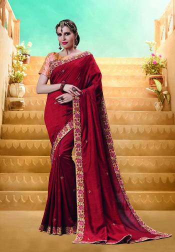 For A Royal Queen Look, Grab This Designer Saree In Maroon Color Paired With Contrasting Peach Colored Blouse. This Saree And Blouse Are Silk Based Beautified With Thread And Jari Emnroidery. This Saree Is Suitable For Festive And Wedding Wear. 