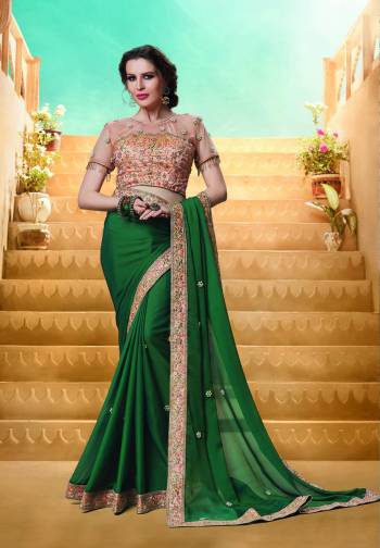 Celebrate This Festive Season Wearing This Designer Saree In Dark Green Color Paired With Contrasting Peach Colored Blouse. This Saree Is Fabricated On Georgette Paired With Art Silk And Net Fabricated Blouse. It Is Light In Weight And Easy To Drape Which Is Easy To Carry All Day Long. 