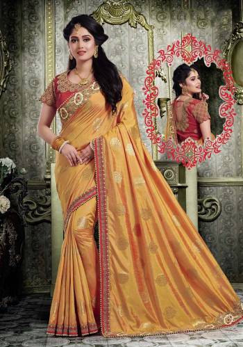 Celebrate This Festive Season Wearing This Designer Saree In Musturd Yellow Color Paired With Contrasting Red Colored Blouse. This Saree And Blouse Are Silk Based Beautified With Embroidery And Weave. 